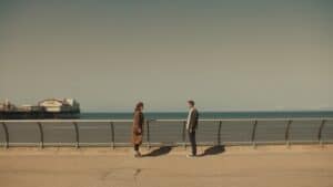 Brighton seafront with two people conversing near the pier, symbolising connection and community in networking events.